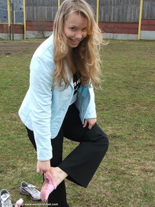 Taking Off Sneakers And Going With Socks Over A Humid Meadow